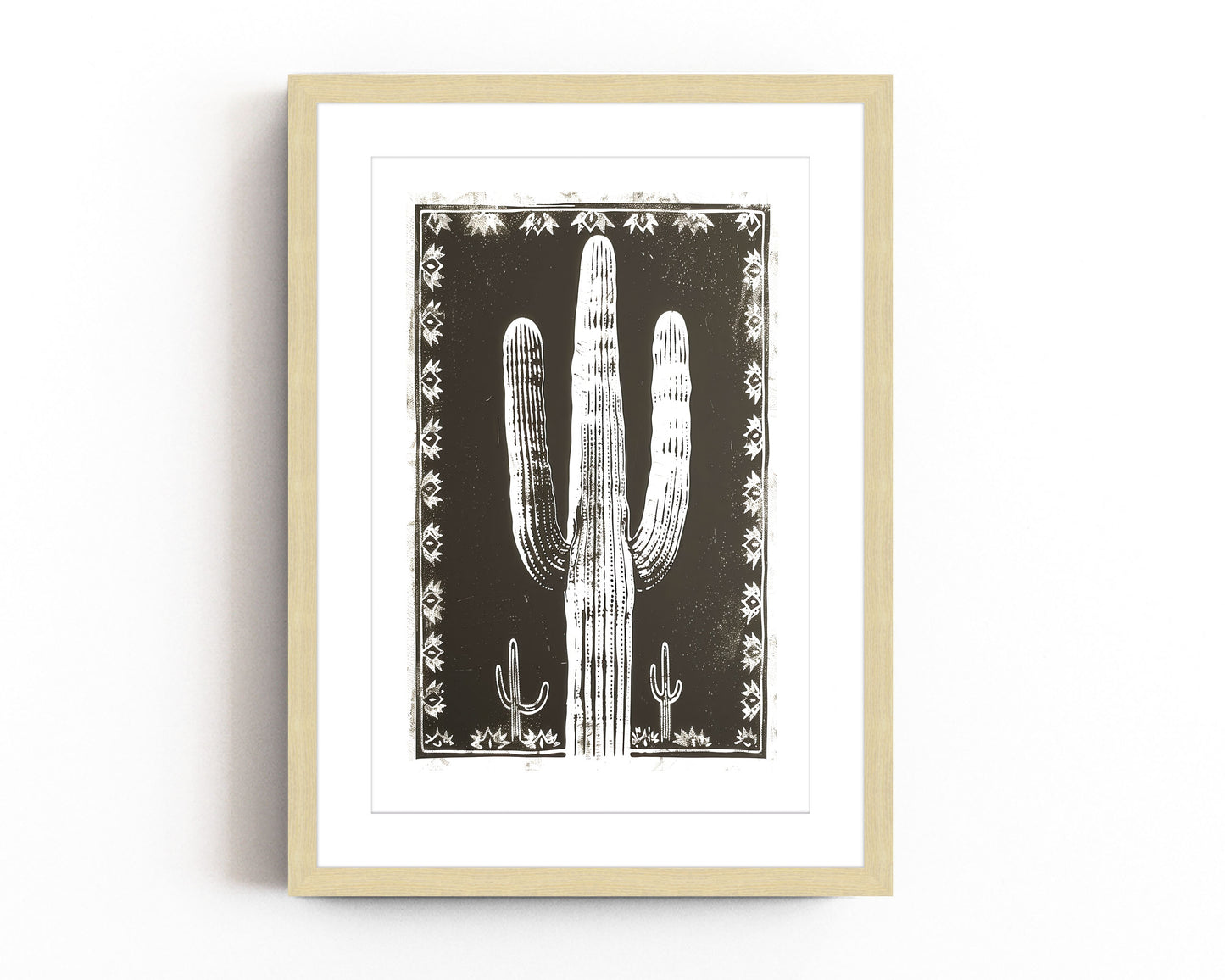 Southwestern cactus art print featuring a bold black and white desert landscape with a large saguaro cactus framed by intricate tribal patterns, perfect for modern southwestern-inspired decor.
