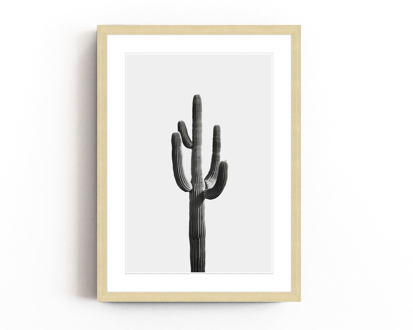 Black and white cactus art print featuring a minimalist design with a tall desert cactus on a plain white background. Perfect for southwestern-inspired decor and modern cactus wall art.