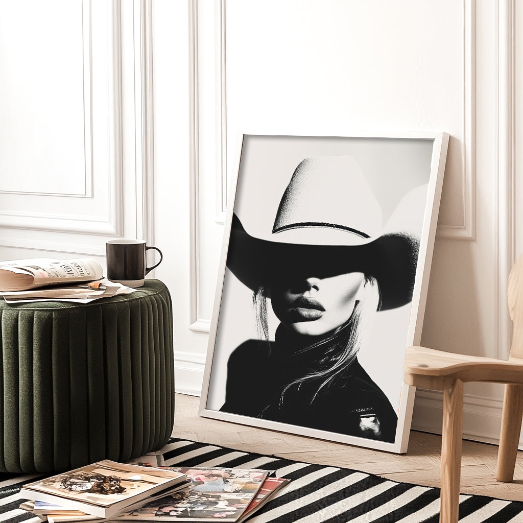 High-contrast black-and-white portrait of a model wearing a cowboy hat, blending minimalist western aesthetics with modern sophistication.