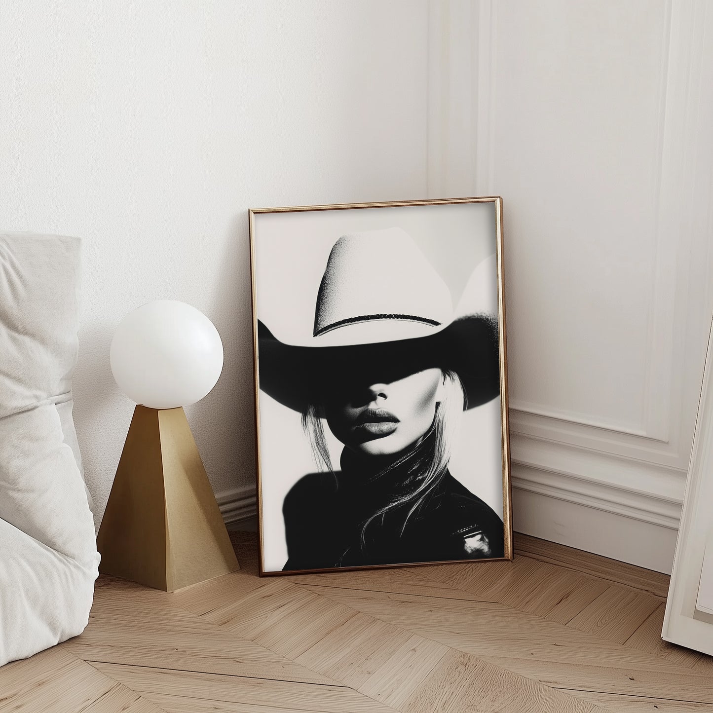 High-contrast black-and-white portrait of a model wearing a cowboy hat, blending minimalist western aesthetics with modern sophistication.