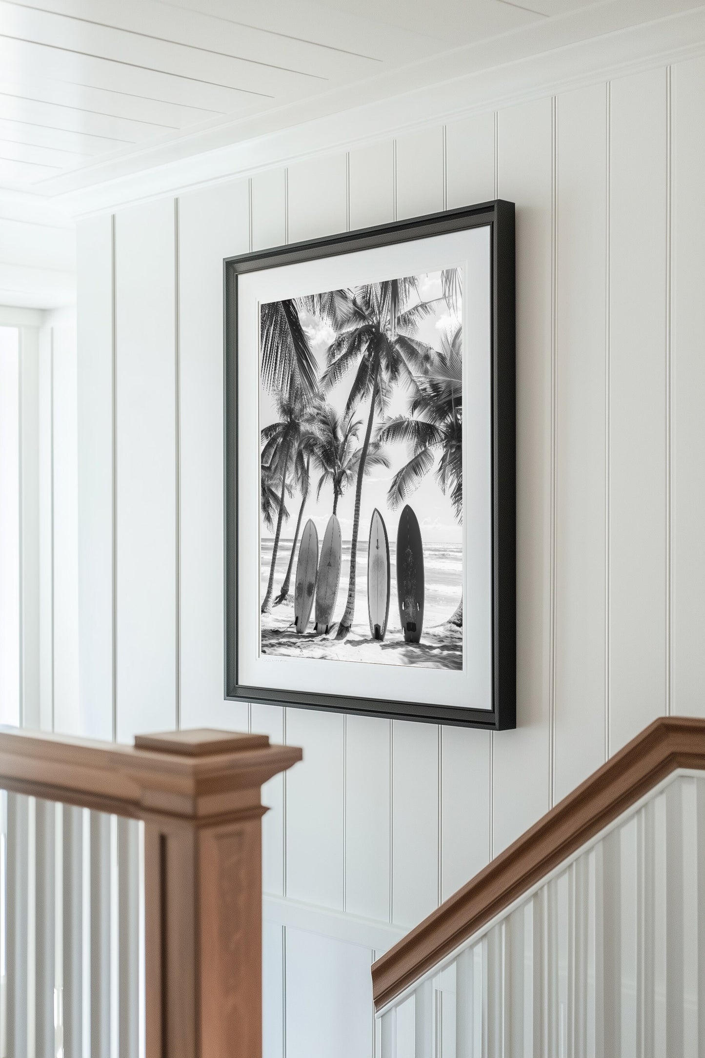 Black and white coastal wall art featuring surfboards lined up against palm trees on a tropical beach, capturing the vintage beach photography style and minimalist coastal decor.