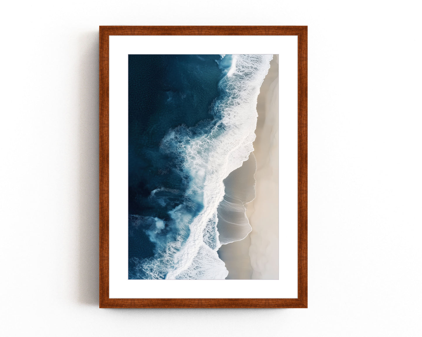 Aerial view of ocean waves crashing onto a sandy beach, showcasing deep blue waters and minimalist coastal scenery, perfect for modern beach home decor.