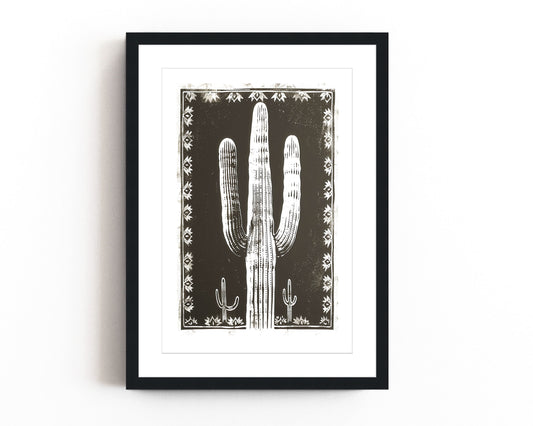 Southwestern cactus art print featuring a bold black and white desert landscape with a large saguaro cactus framed by intricate tribal patterns, perfect for modern southwestern-inspired decor.