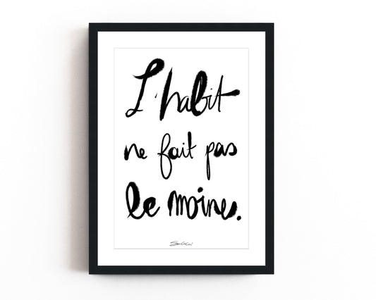 French typography print with “L’habit ne fait pas le moine” phrase in modern calligraphy style, black and white minimalist wall art.