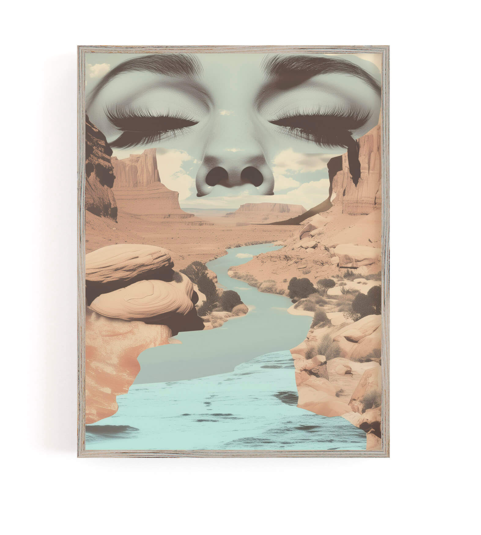 A framed art print featuring a surreal landscape with a desert canyon and winding river, overlaid with a large closed female face in muted blue-gray tones.