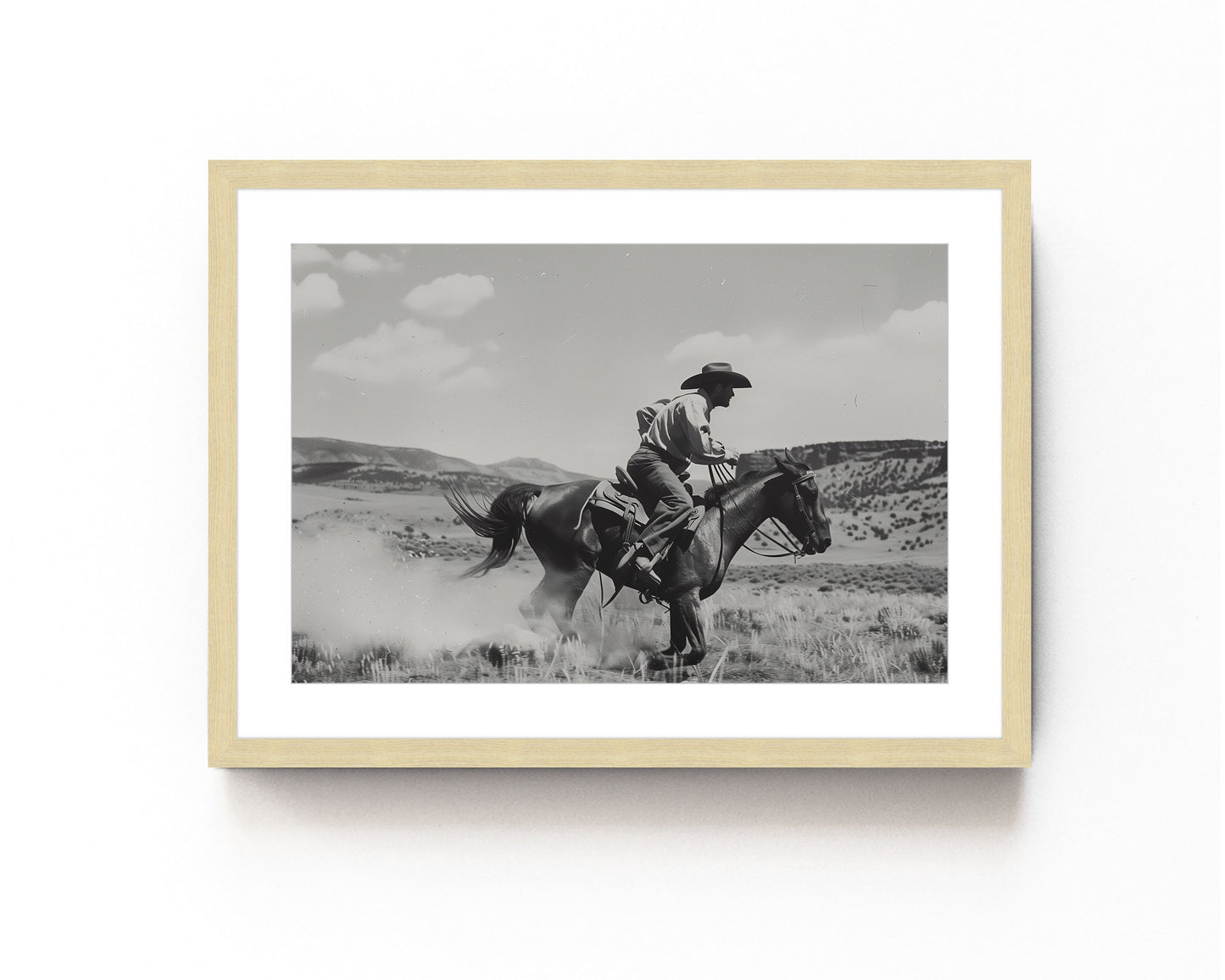 Black and white photography art featuring a cowboy riding a horse in a Western landscape, capturing the dynamic motion and timeless spirit of the Old West.