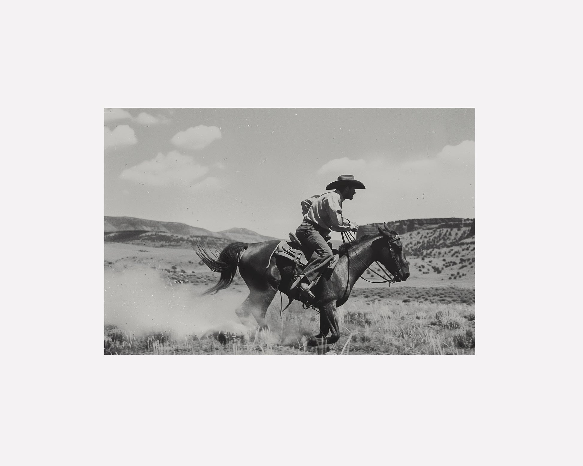 Black and white photography art featuring a cowboy riding a horse in a Western landscape, capturing the dynamic motion and timeless spirit of the Old West.