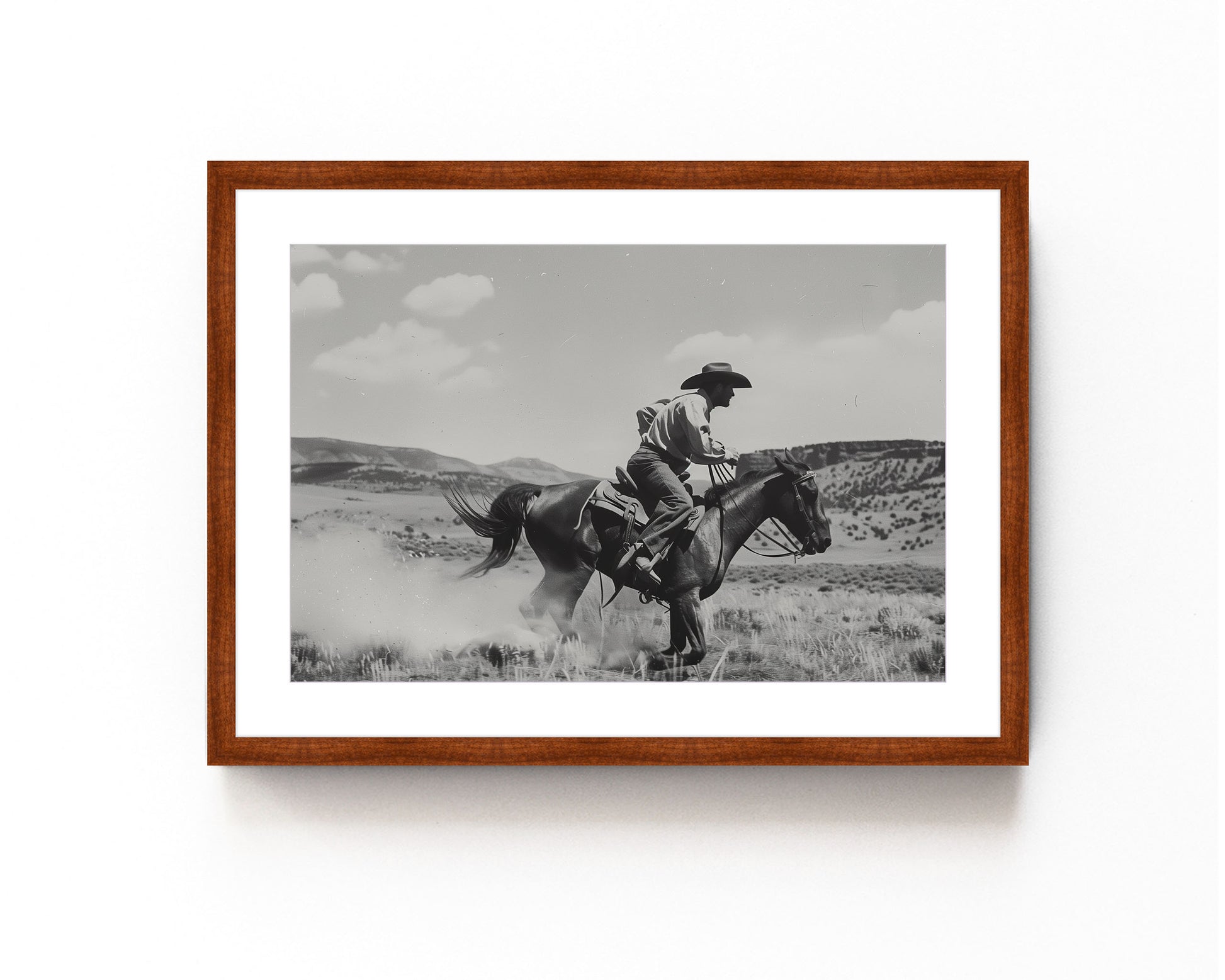 Black and white photography art featuring a cowboy riding a horse in a Western landscape, capturing the dynamic motion and timeless spirit of the Old West.