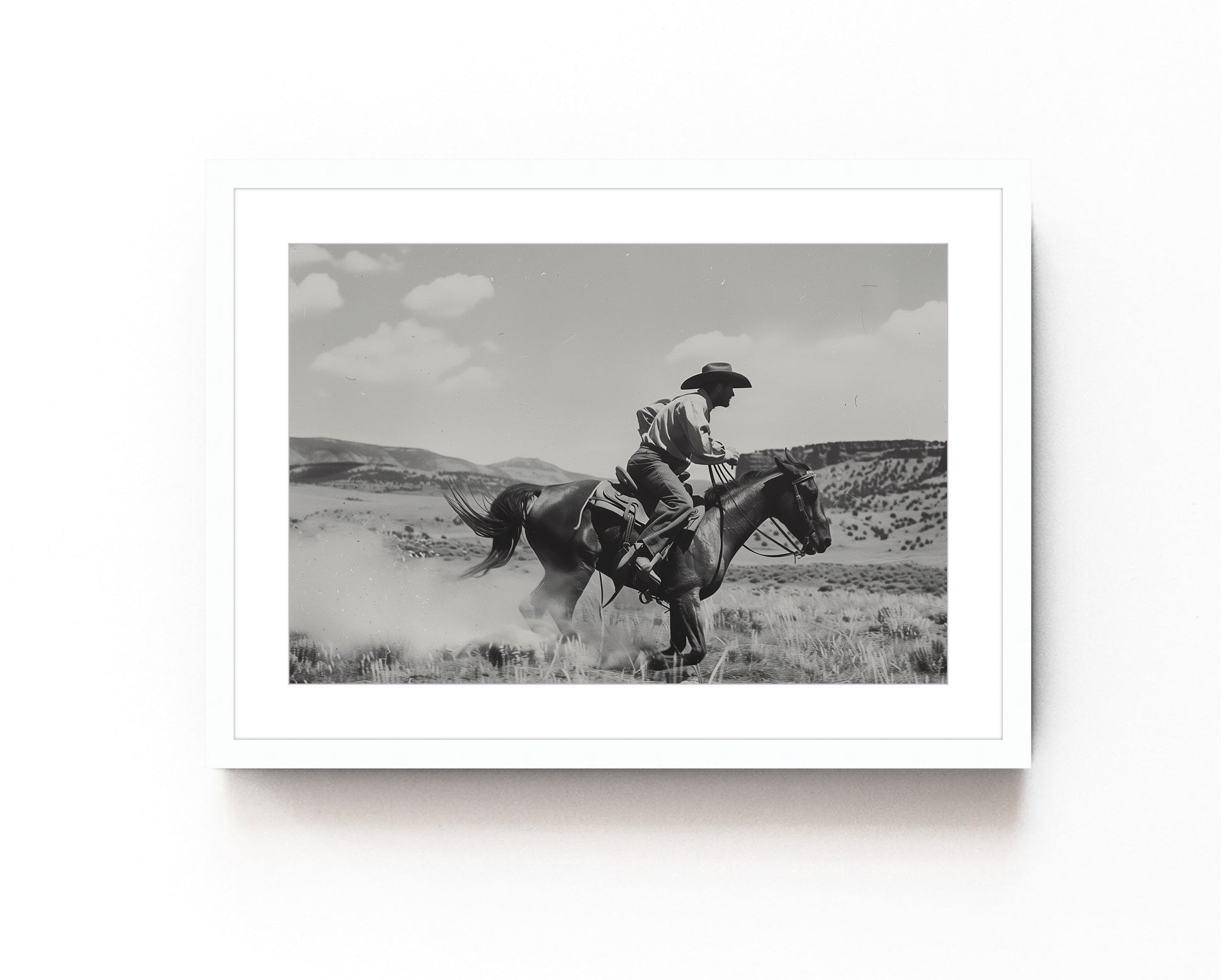 Black and white photography art featuring a cowboy riding a horse in a Western landscape, capturing the dynamic motion and timeless spirit of the Old West.