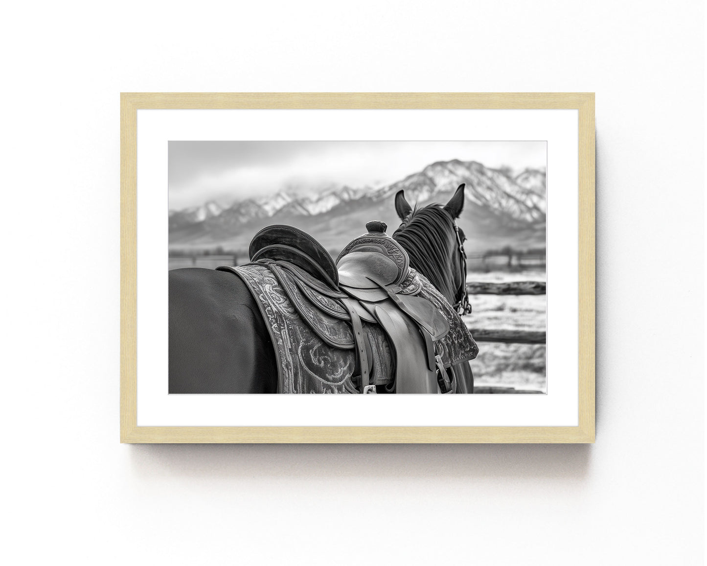 Black and white horse photography print featuring a horse with a detailed western saddle, set against a mountain landscape. Ideal for rustic equestrian decor and western-inspired art.