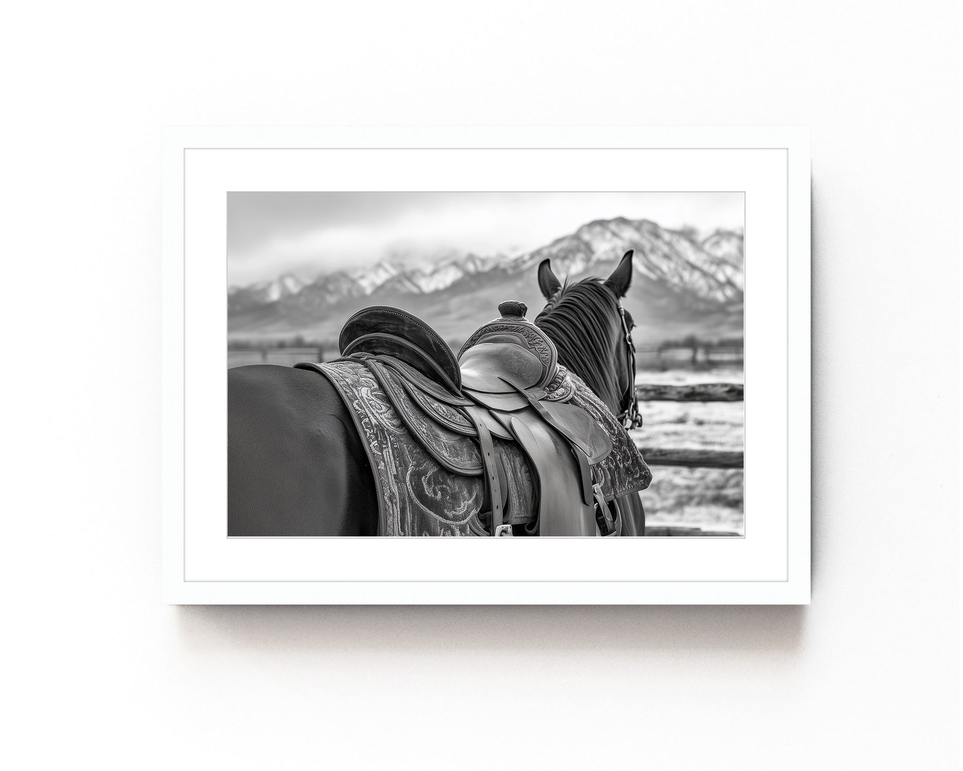 Black and white horse photography print featuring a horse with a detailed western saddle, set against a mountain landscape. Ideal for rustic equestrian decor and western-inspired art.