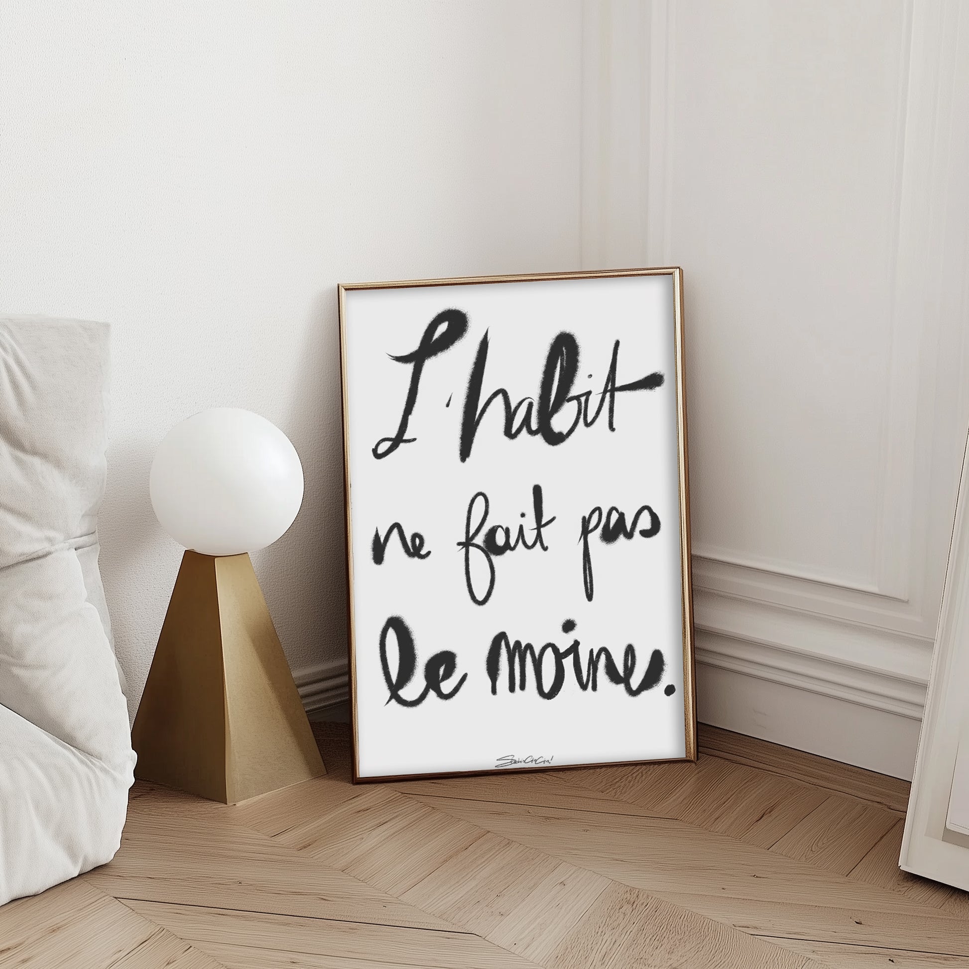 French typography print with “L’habit ne fait pas le moine” phrase in modern calligraphy style, black and white minimalist wall art.