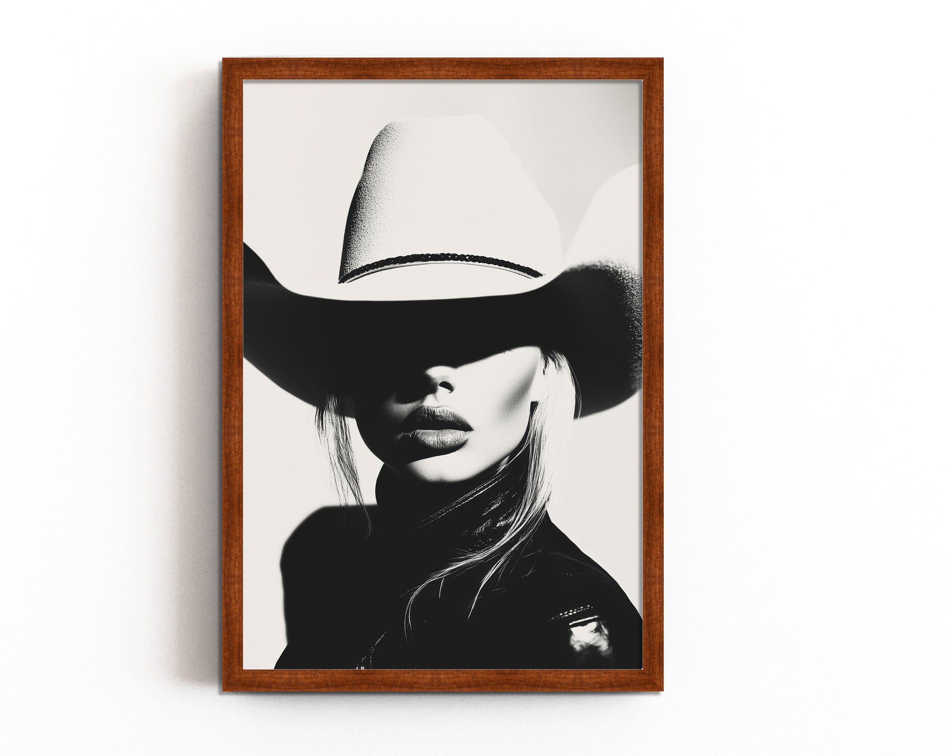 High-contrast black-and-white portrait of a model wearing a cowboy hat, blending minimalist western aesthetics with modern sophistication.