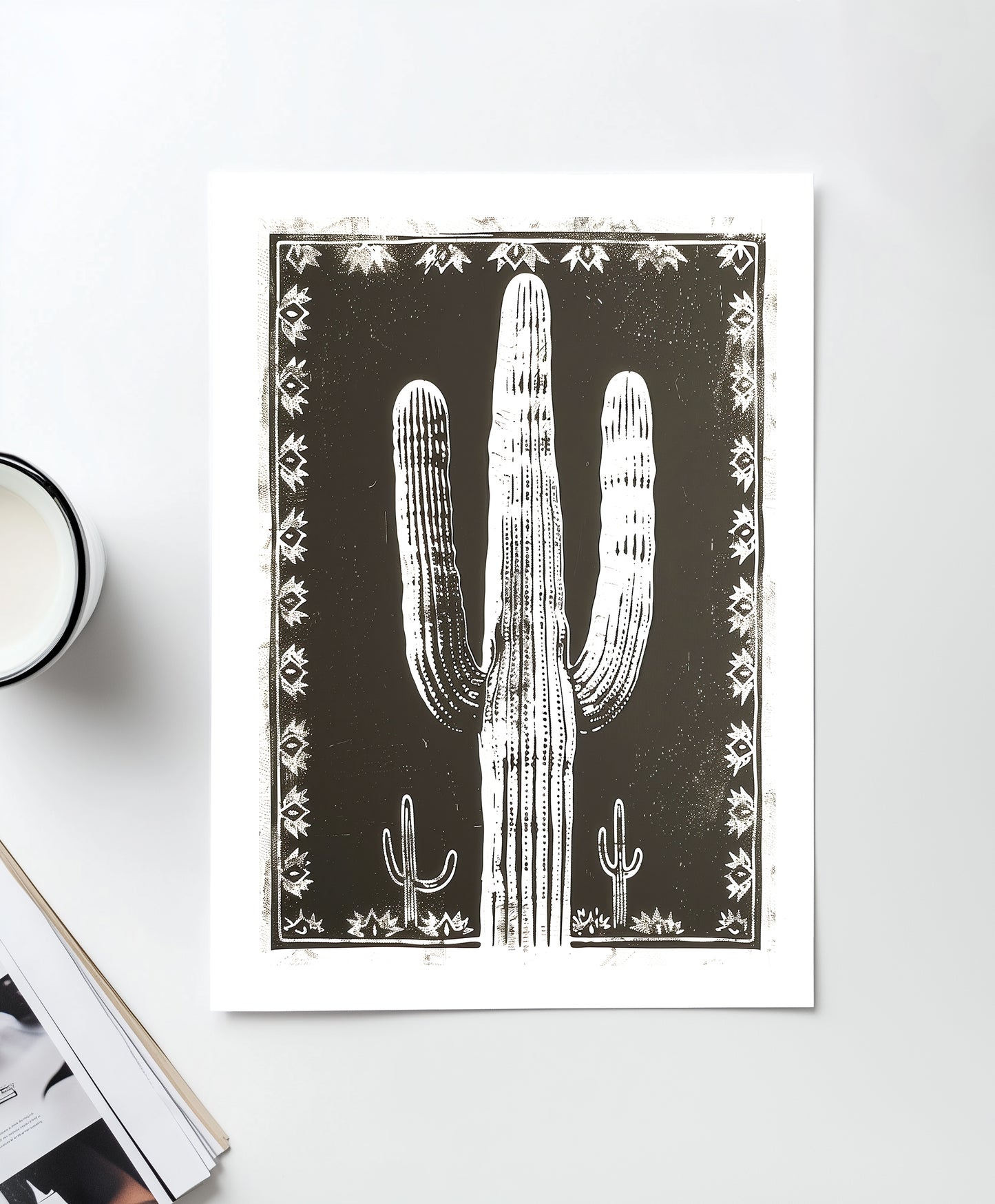 Southwestern-inspired cactus wall art featuring a bold saguaro cactus in neutral tones, framed with intricate designs on a black background.