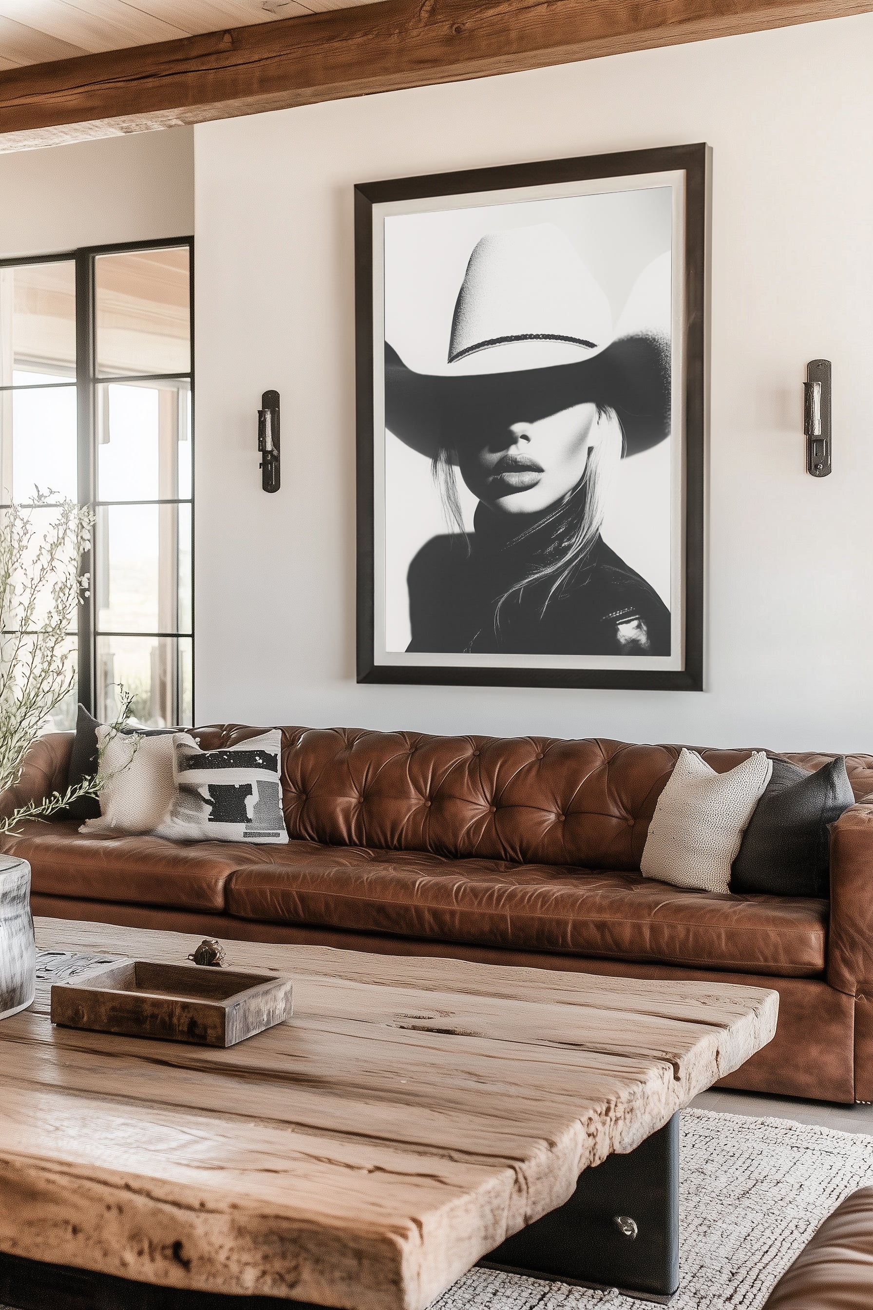 High-contrast black-and-white portrait of a model wearing a cowboy hat, blending minimalist western aesthetics with modern sophistication.