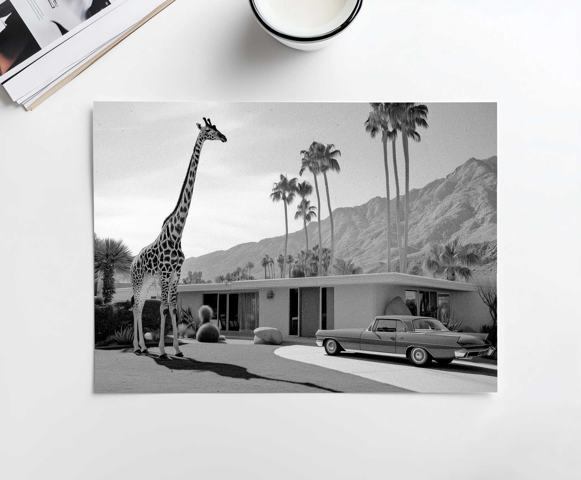 A black-and-white vintage-inspired photograph featuring a giraffe standing next to a classic Palm Springs mid-century home with a retro car and desert backdrop, part of the Palm Springs Menagerie series.