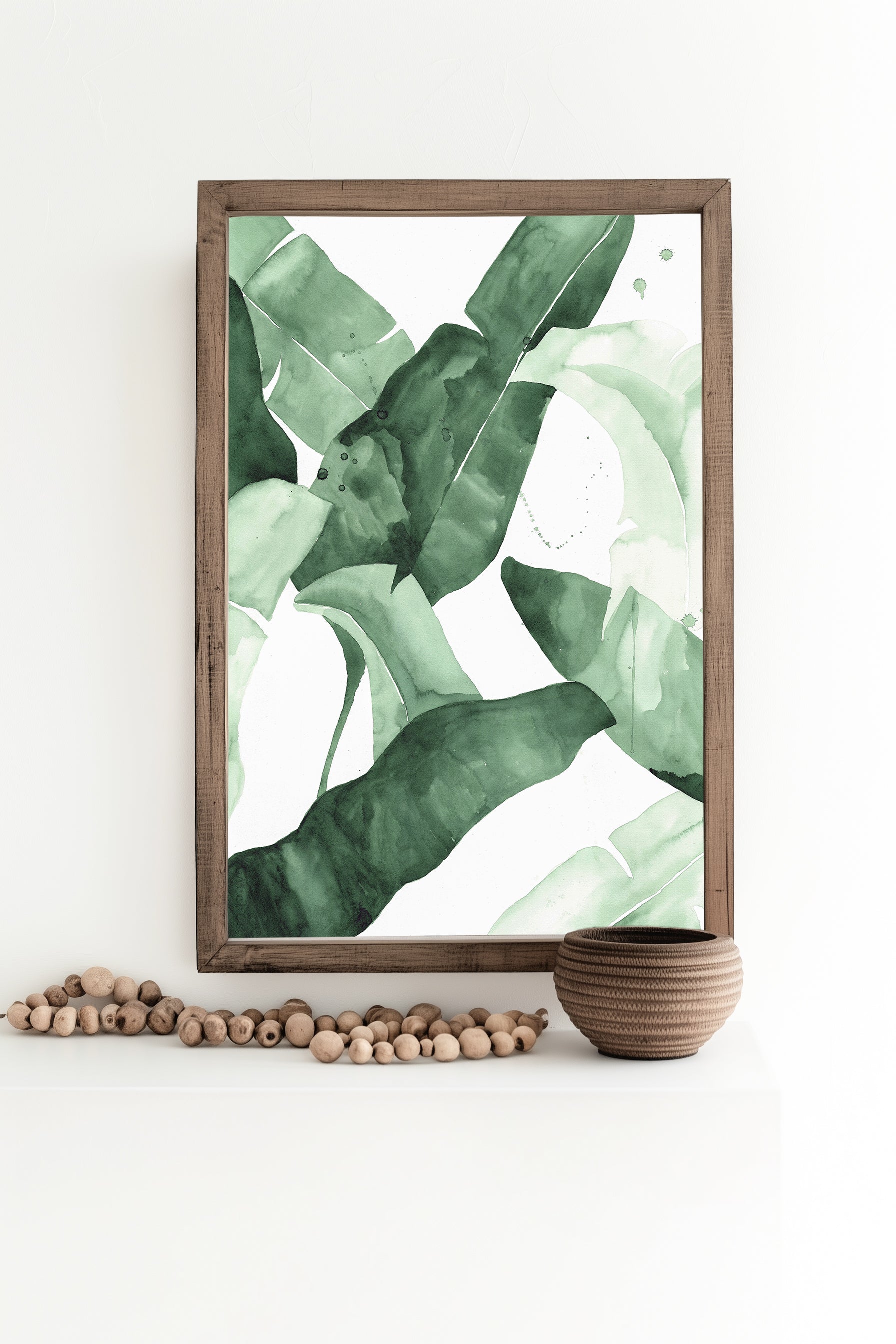 Abstract watercolor artwork featuring banana leaves in various shades of green, creating a tropical and nature-inspired aesthetic.