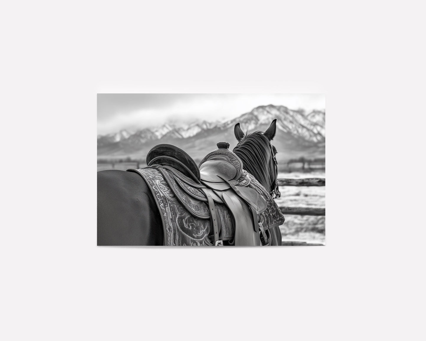 Black and white horse photography print featuring a horse with a detailed western saddle, set against a mountain landscape. Ideal for rustic equestrian decor and western-inspired art.