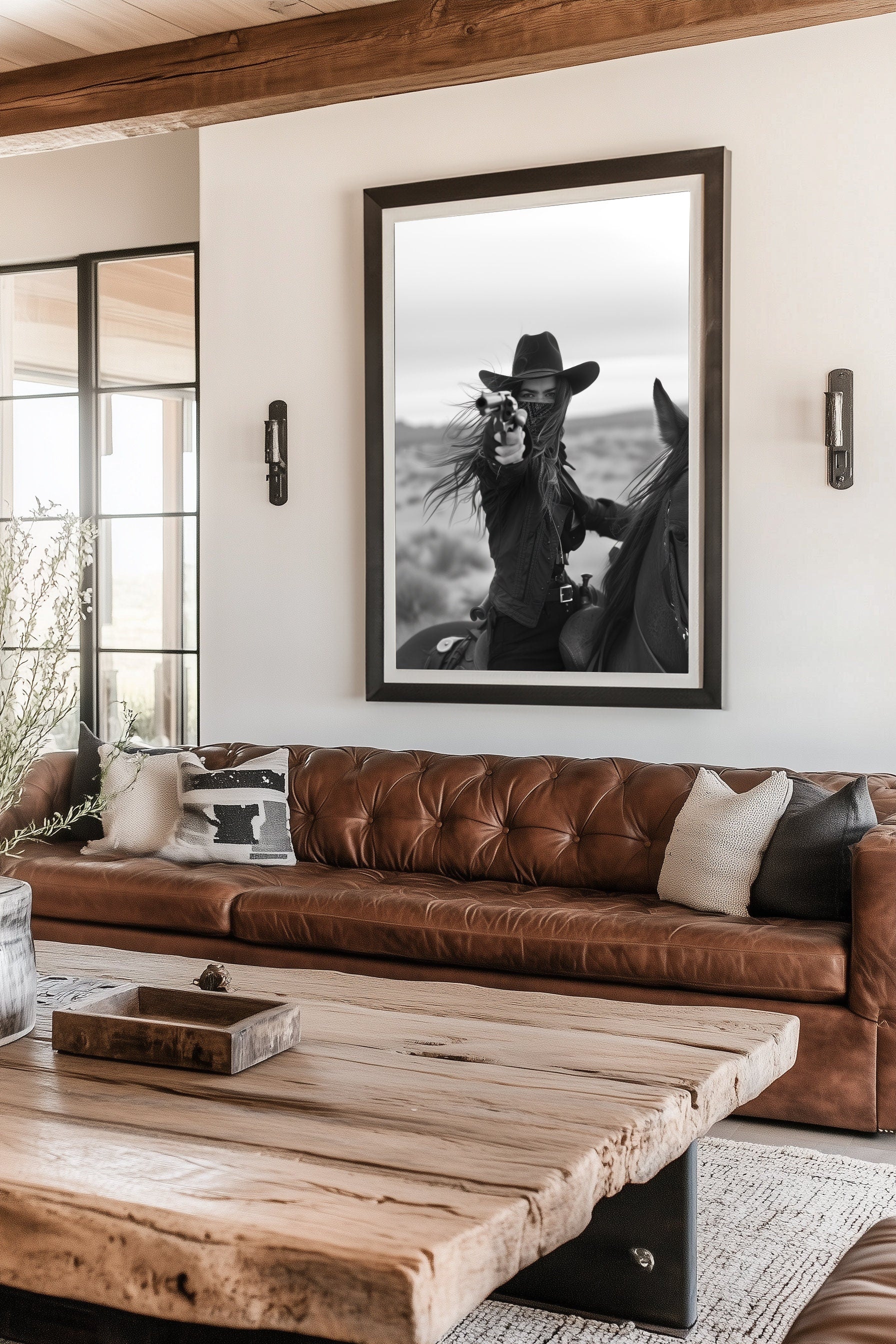 Black and white photograph of a female cowboy riding a horse, wearing a hat and bandana, aiming a revolver directly at the camera. The image captures a powerful, dramatic moment with a Western theme.