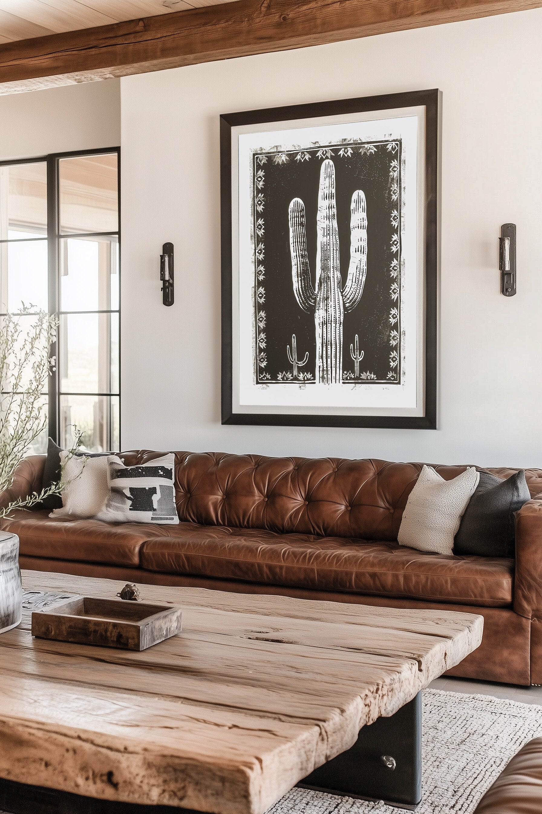 Southwestern-inspired cactus wall art featuring a bold saguaro cactus in neutral tones, framed with intricate designs on a black background.