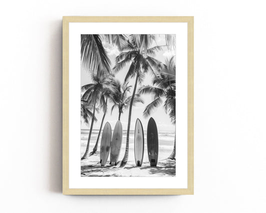 Black and white coastal wall art featuring surfboards lined up against palm trees on a tropical beach, capturing the vintage beach photography style and minimalist coastal decor.