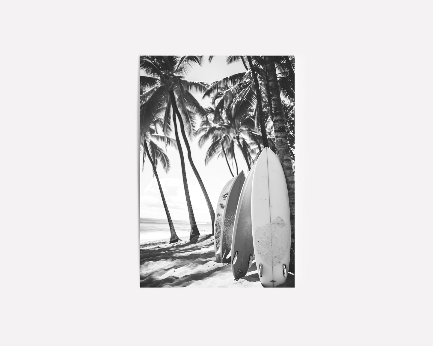 Black and white surfboard art print featuring surfboards resting on a beach under palm trees, capturing the essence of coastal living.
