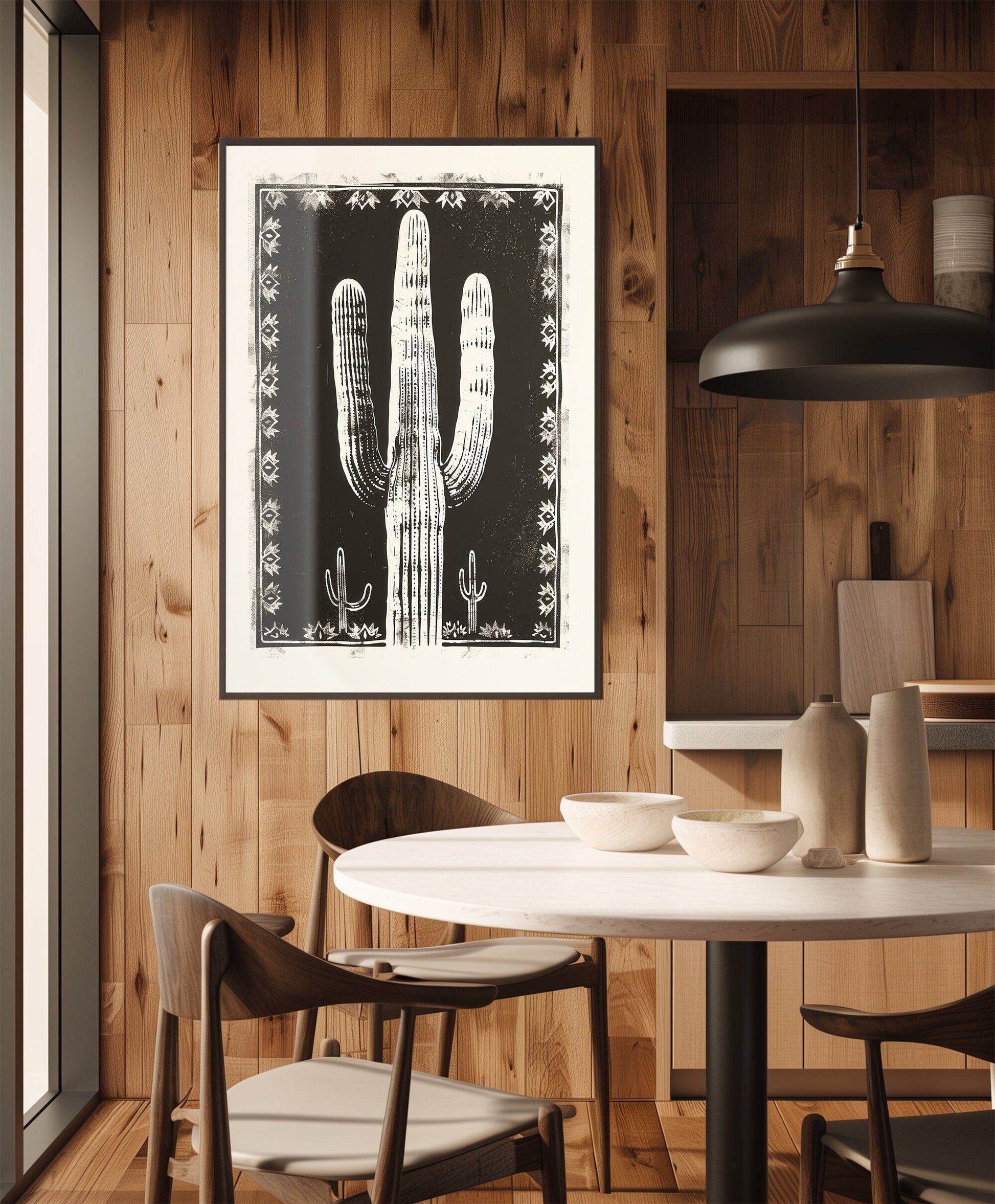 Southwestern-inspired cactus wall art featuring a bold saguaro cactus in neutral tones, framed with intricate designs on a black background.