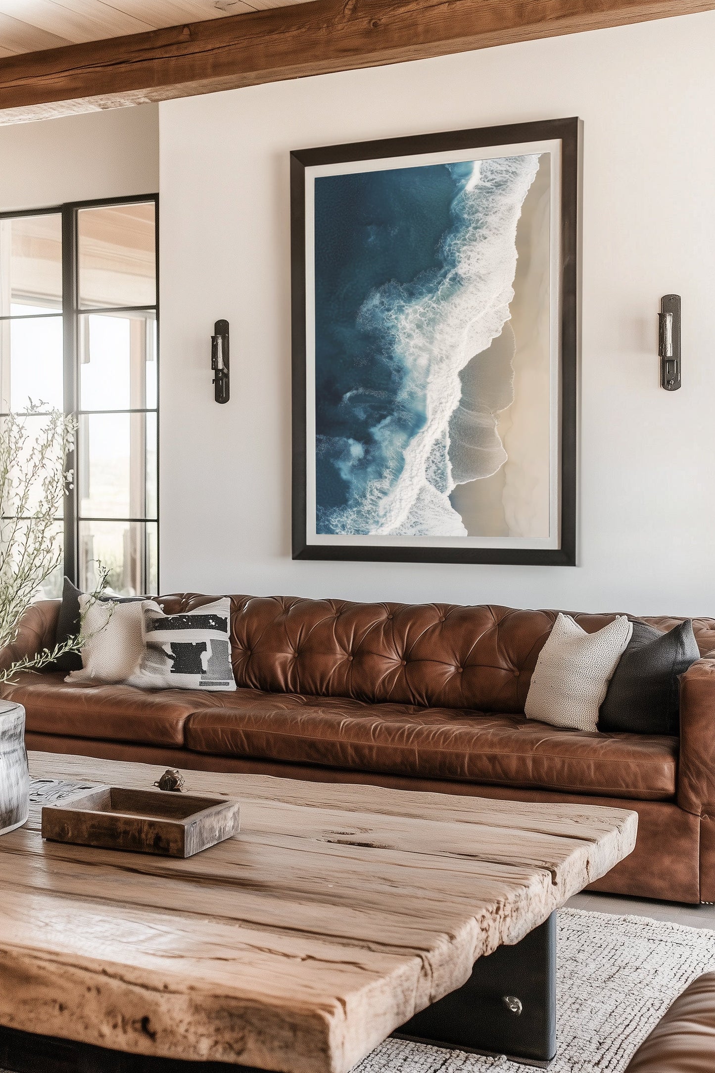 Aerial view of ocean waves crashing onto a sandy beach, showcasing deep blue waters and minimalist coastal scenery, perfect for modern beach home decor.