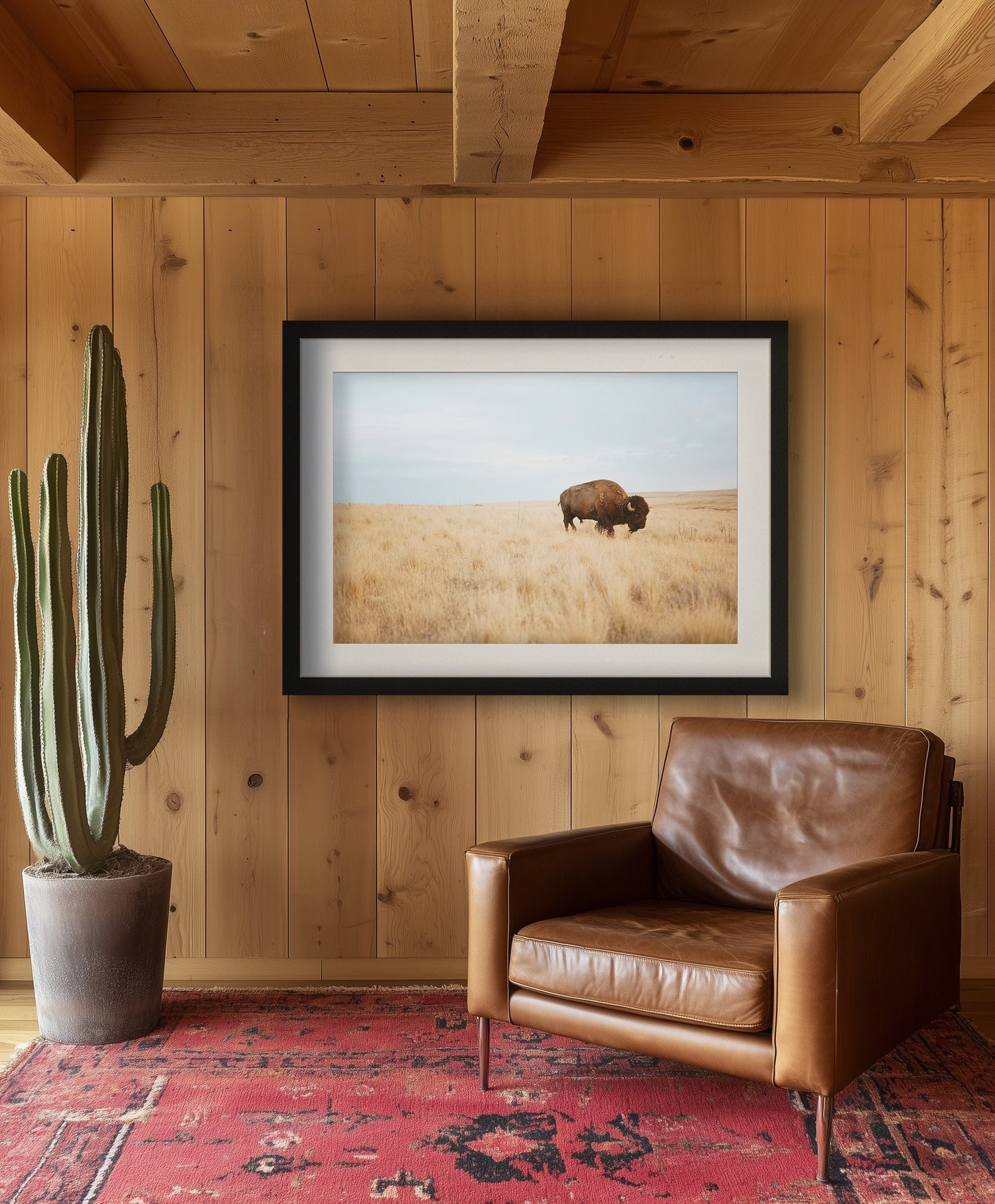 Bison standing in a vast golden prairie under a clear sky, captured in a wildlife photography print.