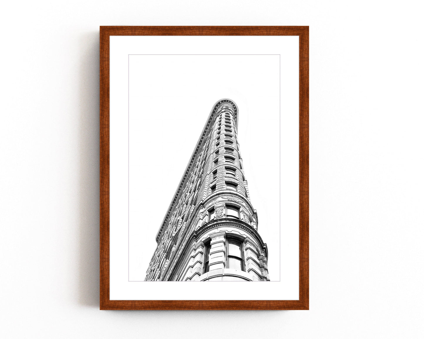 Black and white photography of the Flatiron Building in New York City, showcasing its iconic architectural elegance and bold structure.