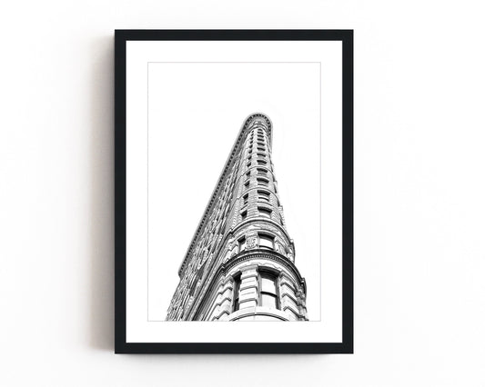 Black and white photography of the Flatiron Building in New York City, showcasing its iconic architectural elegance and bold structure.