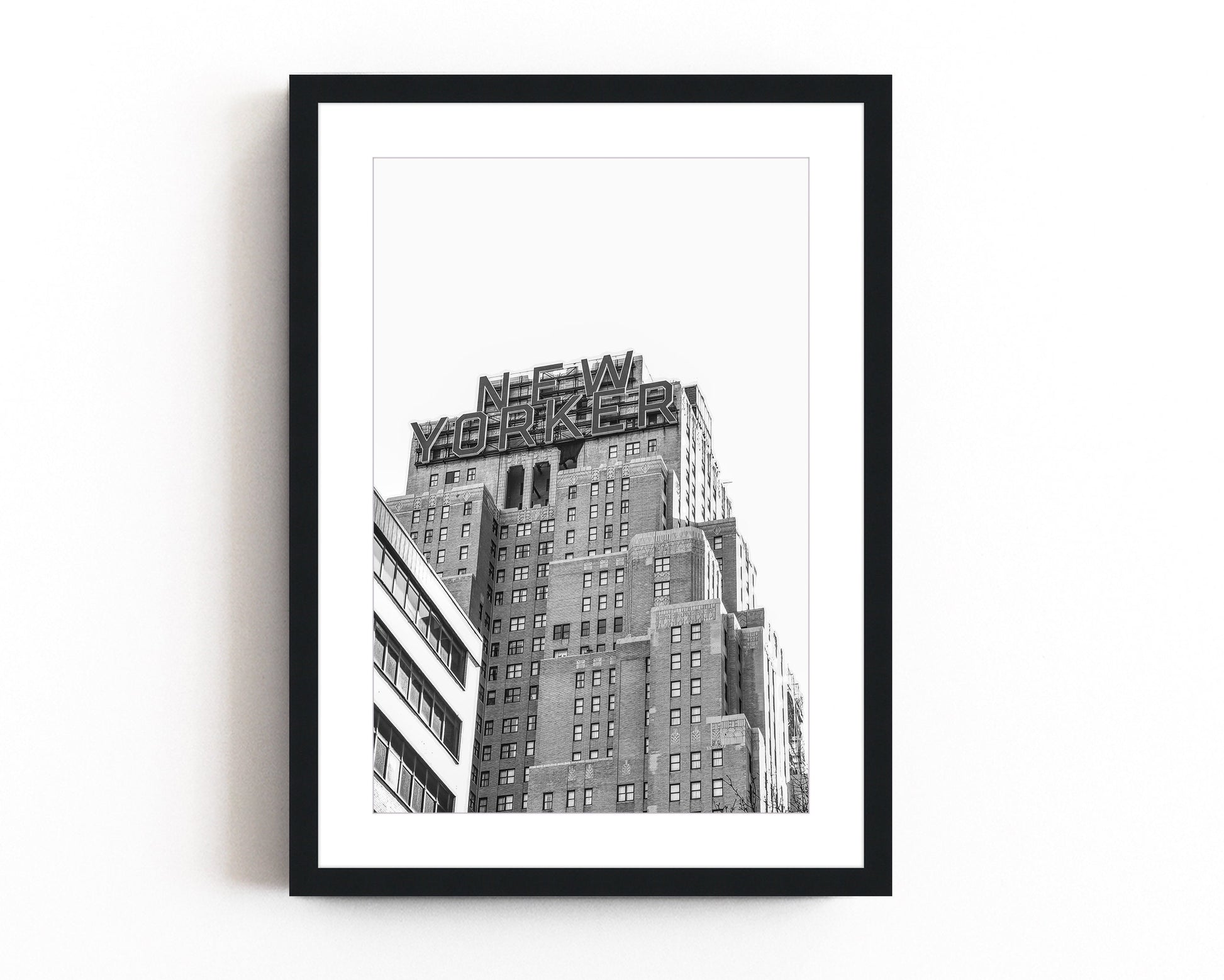 Black and white art print of the iconic New Yorker building in Manhattan, showcasing urban skyscraper architecture with a vintage cityscape feel.