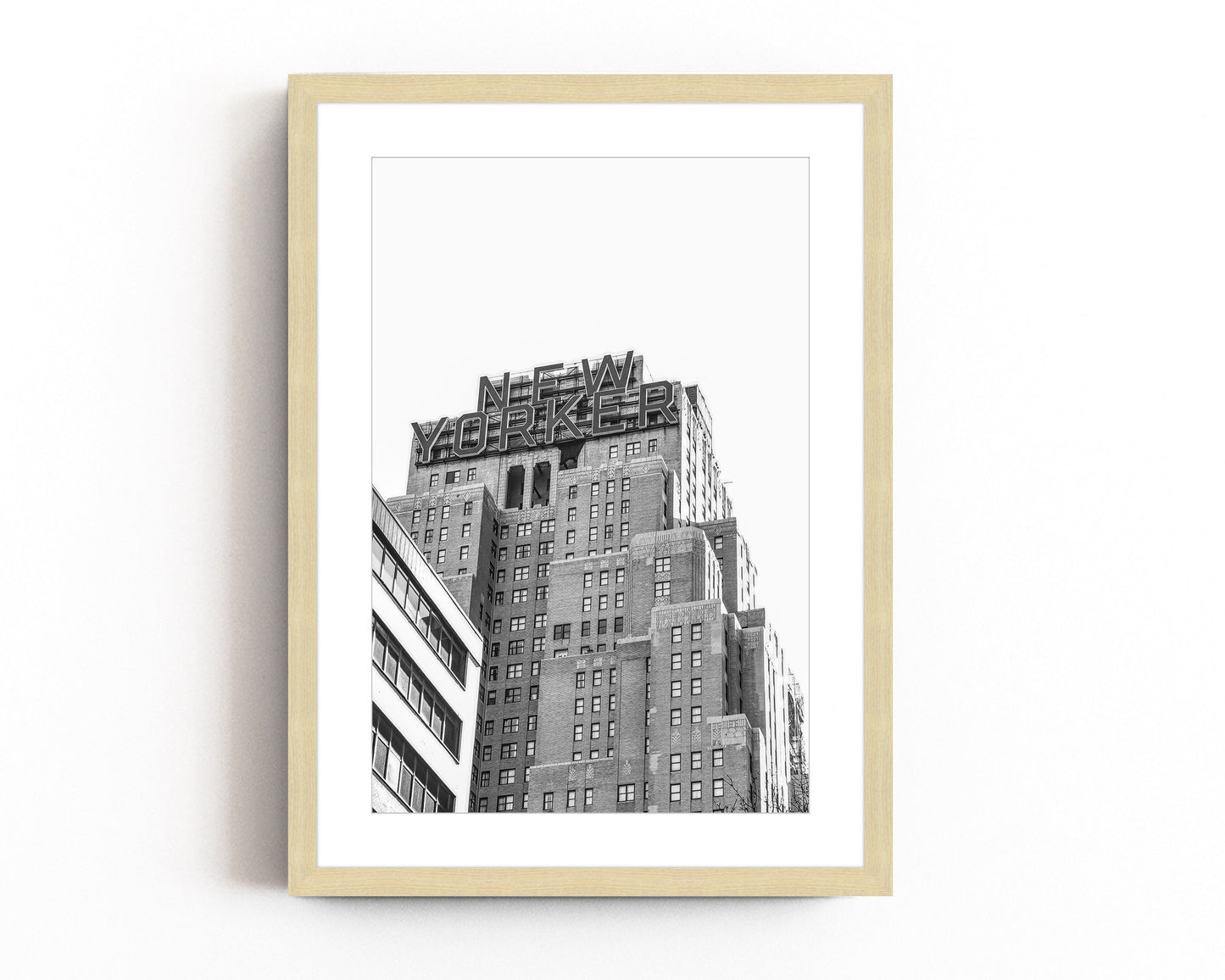 Black and white art print of the iconic New Yorker building in Manhattan, showcasing urban skyscraper architecture with a vintage cityscape feel.