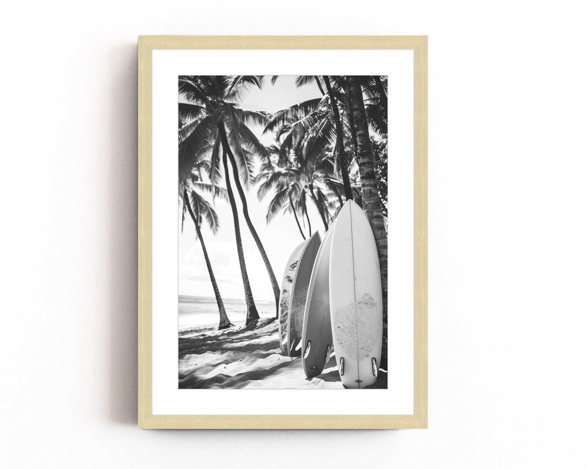 Black and white surfboard art print featuring surfboards resting on a beach under palm trees, capturing the essence of coastal living.
