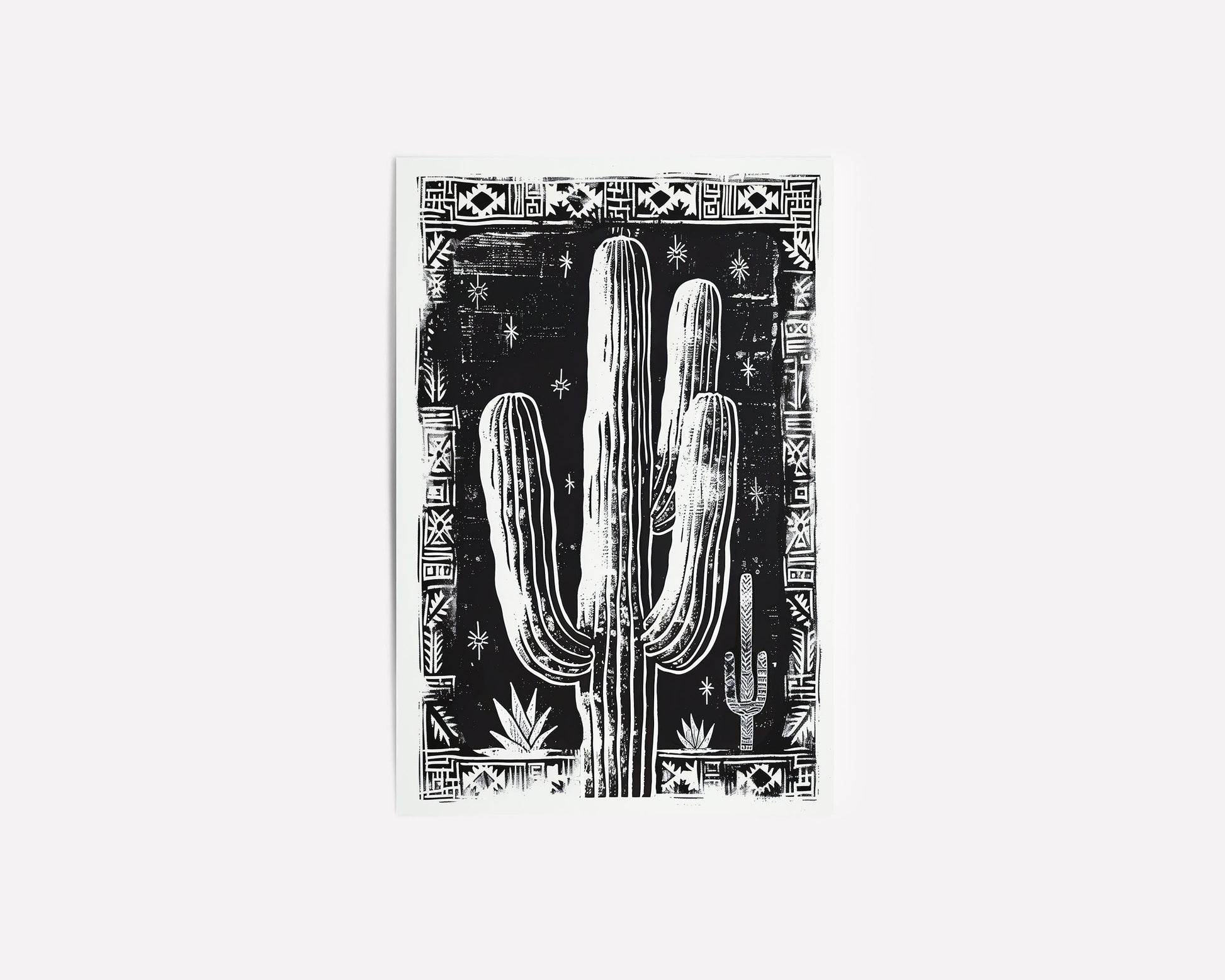 Black and white cactus art print with tribal border, perfect for boho and southwestern-inspired decor, showcasing bold desert design elements.