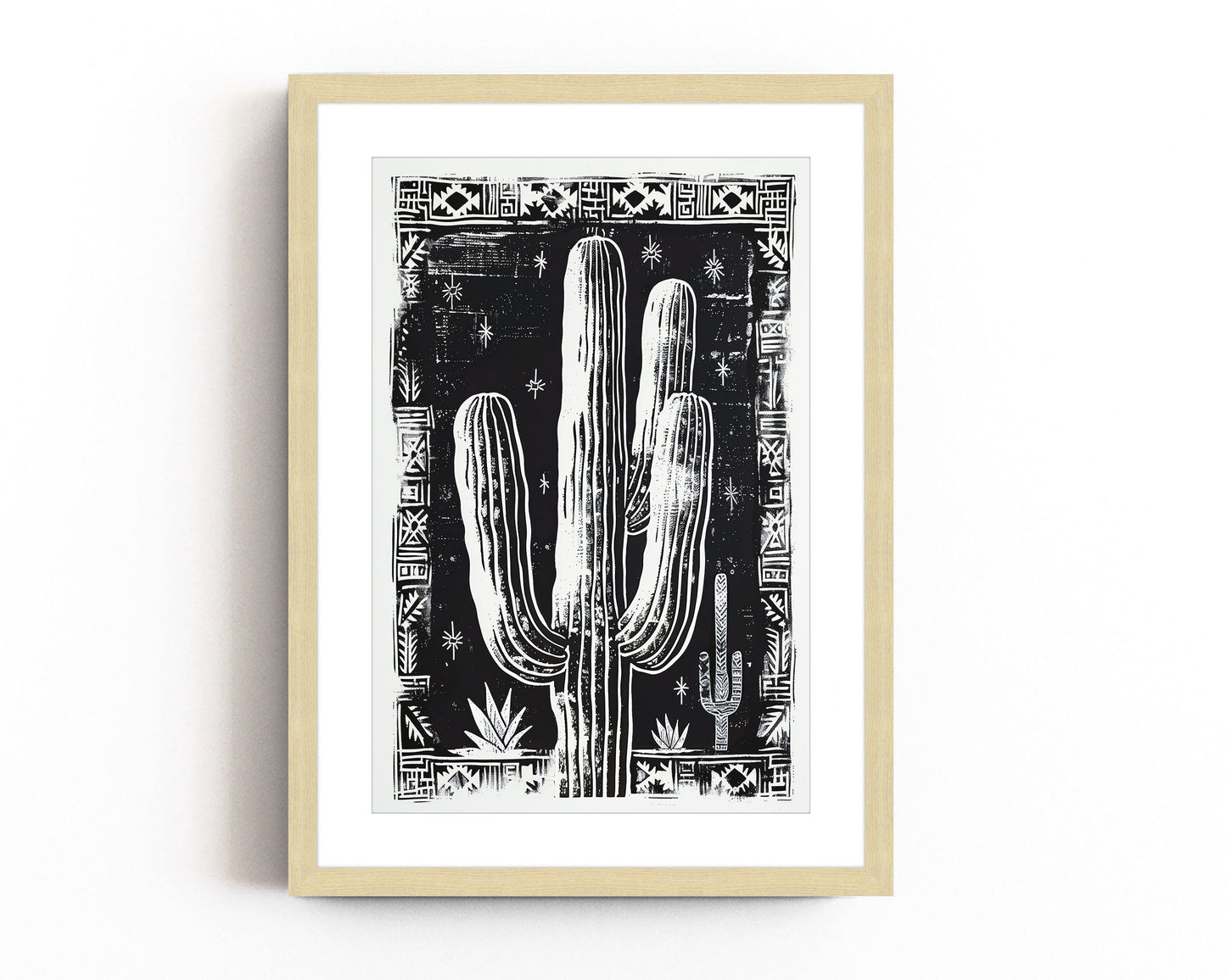 Black and white cactus art print with tribal border, perfect for boho and southwestern-inspired decor, showcasing bold desert design elements.