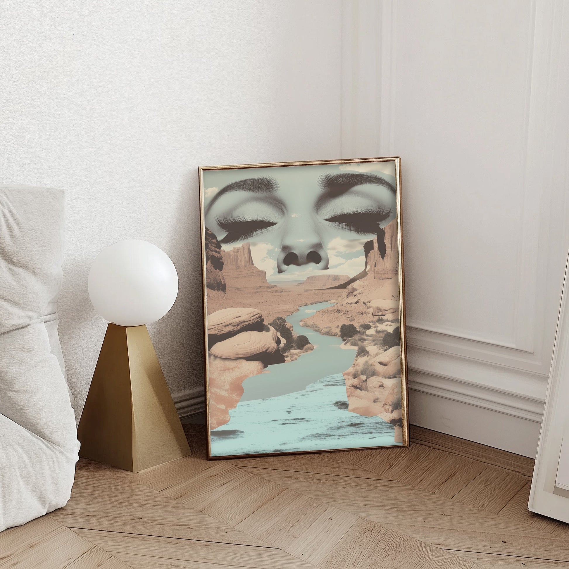 Surreal art print featuring a serene face merging with a desert canyon landscape and flowing river, blending nature and human elements in a dreamlike composition.