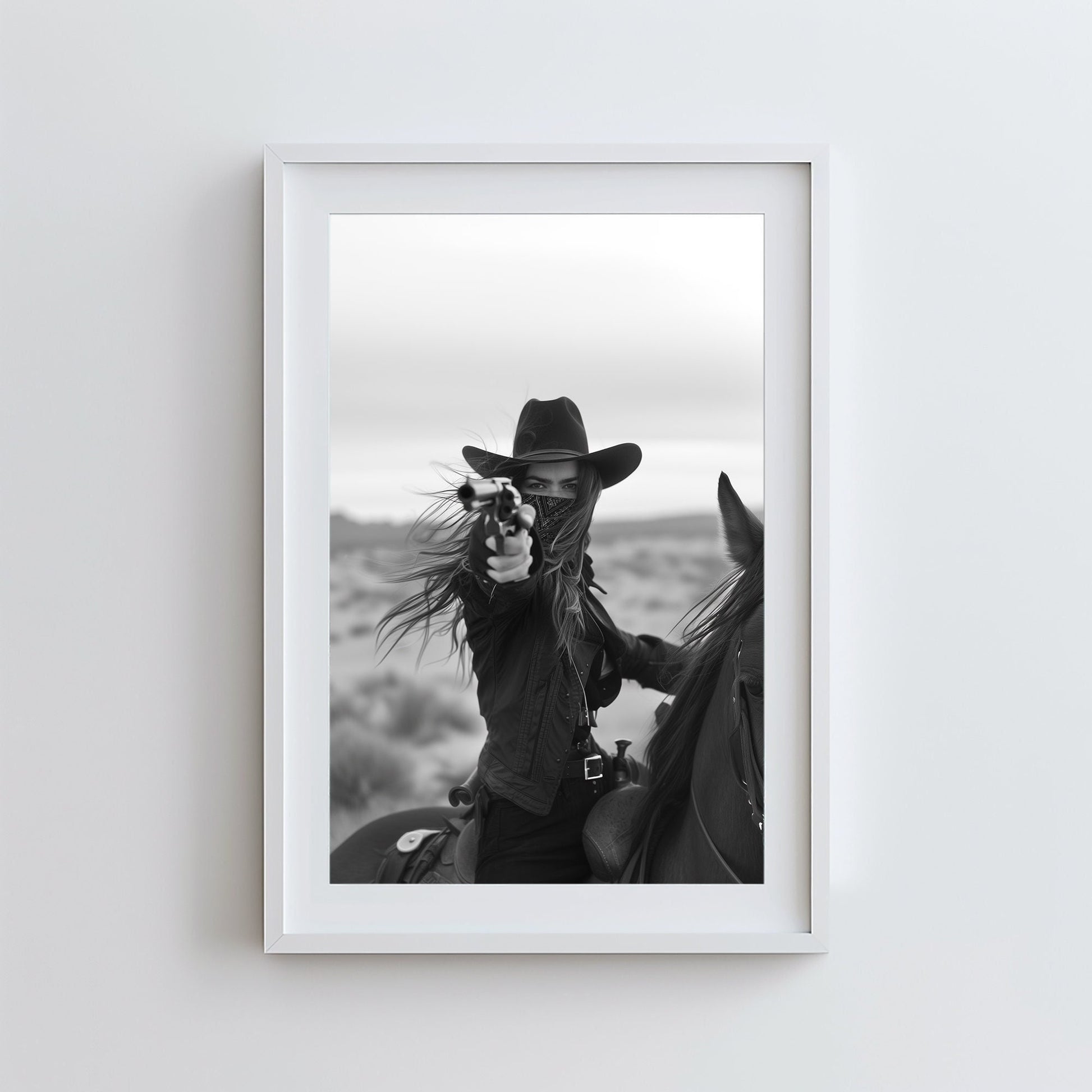 Black and white photograph of a female cowboy riding a horse, wearing a hat and bandana, aiming a revolver directly at the camera. The image captures a powerful, dramatic moment with a Western theme.