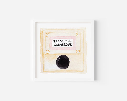  “Press for Champagne” minimalist wall art print featuring a watercolor champagne button design in a wooden frame, photographed for modern decor.
