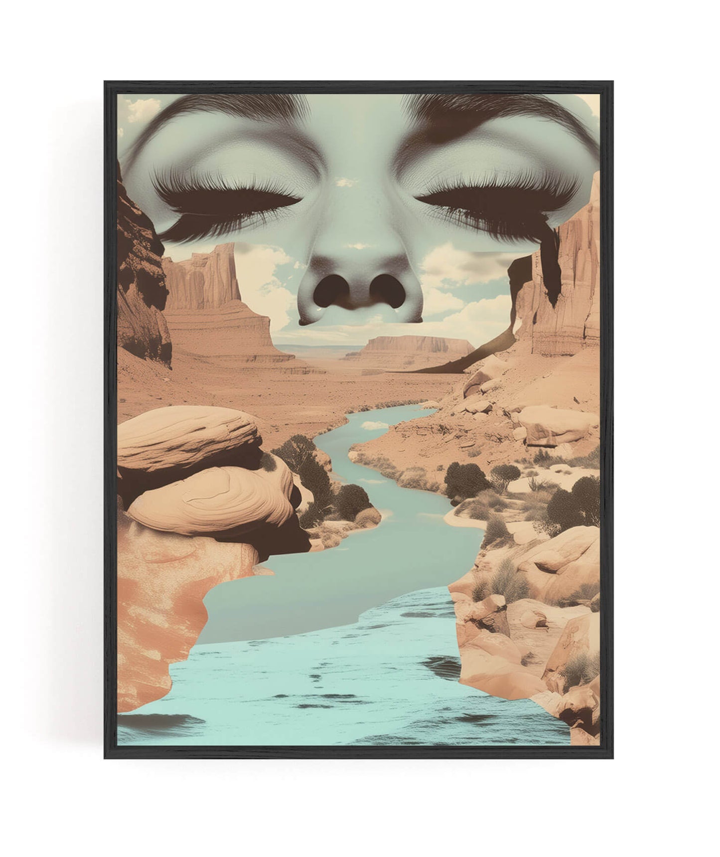 A framed art print featuring a surreal desert canyon landscape with a river, overlaid with a large stylized face of closed eyes and long lashes, shown against a plain white background.